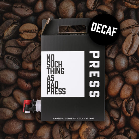 Decaf press coffee packaging with coffee beans on a dark background