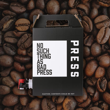Black box with 'PRESS' text on coffee beans