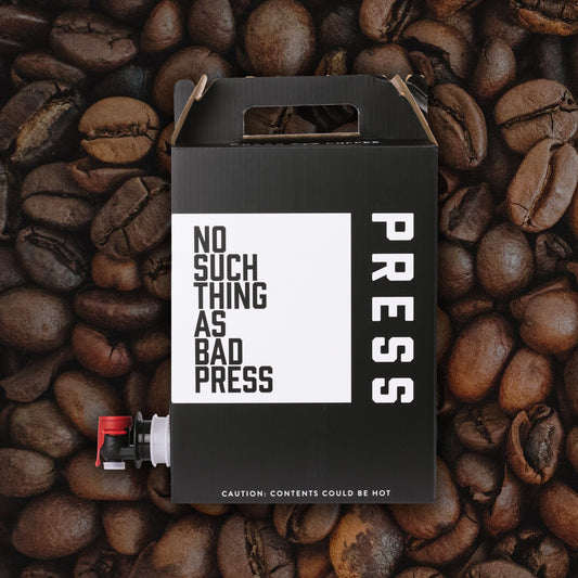 Black box with 'PRESS' text on coffee beans