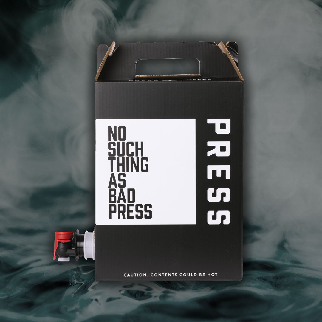 Black box with 'PRESS' text and a white label on a background of hot water