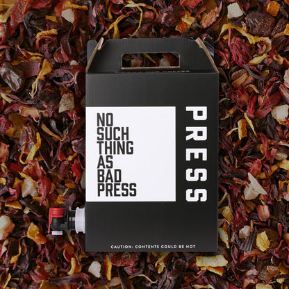 Black box with 'No Such Thing as Bad Press' text on a bed of colorful dried leaves.